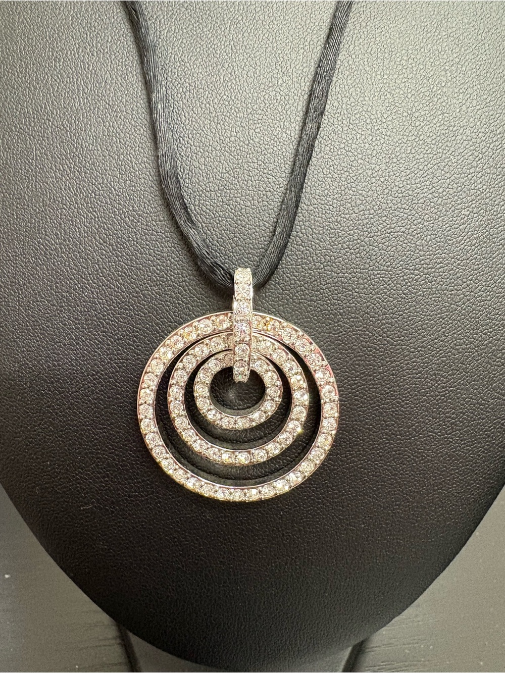 Nolan Miller rhinestone necklace on black silk cord.